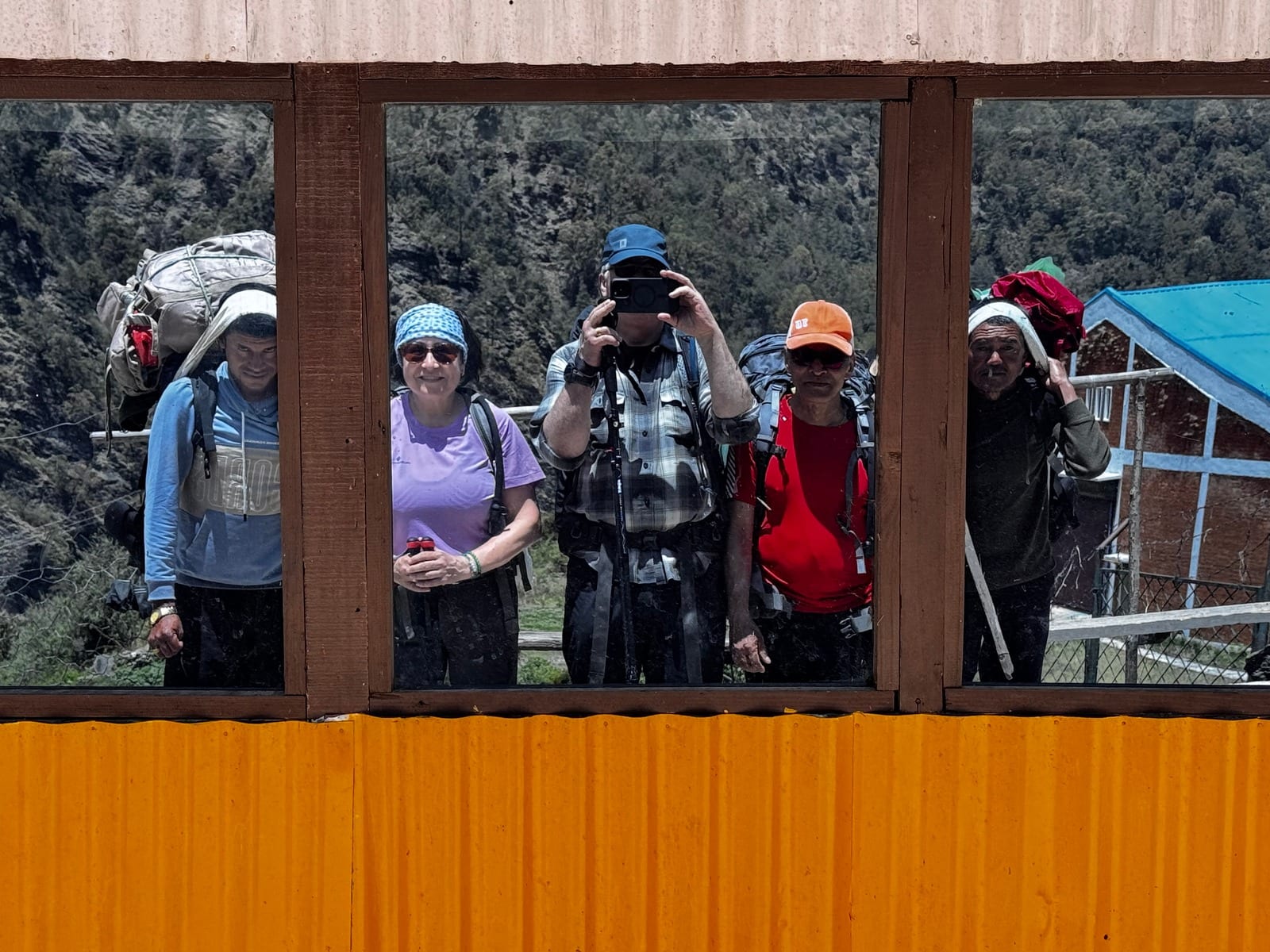 Trekkers framed in a teahouse window