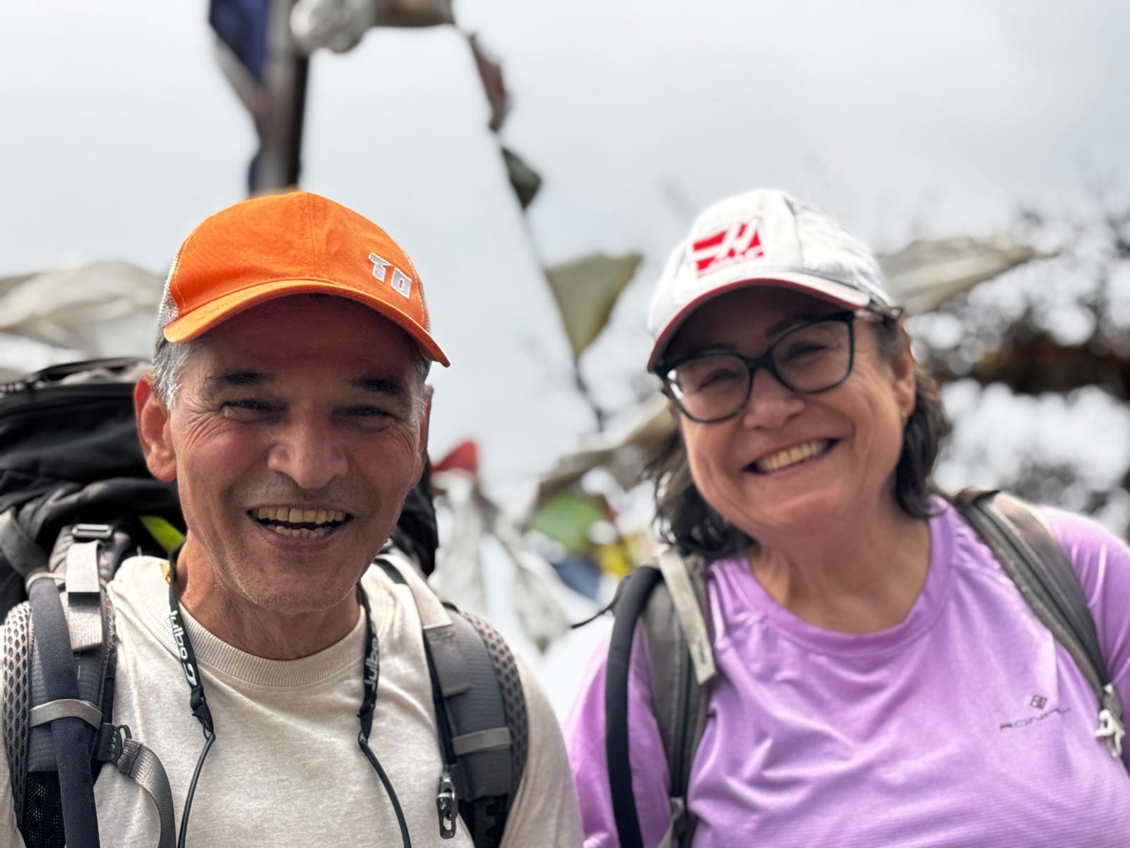 Guide and trekker at the top, packs still on